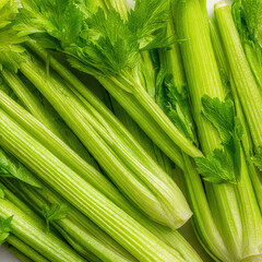 Obraz premium A bunch of celery displayed on a clean surface, highlighting vibrant green tones and crunchy texture. Great for grocery catalogs and healthy lifestyle promotions.