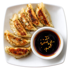 Crispy pan fried gyoza dumplings served with soy sauce dipping sauce on a white plate