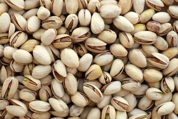 Many tasty unpeeled pistachios top view flat lay background pattern