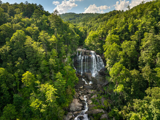 Amazing summer landscape with forest river waters falling down in big waterfall with clear water between rocky boulders in Nantahala National Forest. Whitewater Falls, North Carolina, USA © bilanol