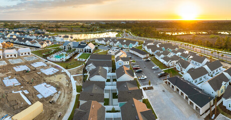 Wooden frames of new cheap American homes under construction. Development of residential housing in...