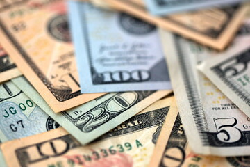 Big amount of different dollar bills close up. Hundred fifty twenty ten and five dollar banknotes