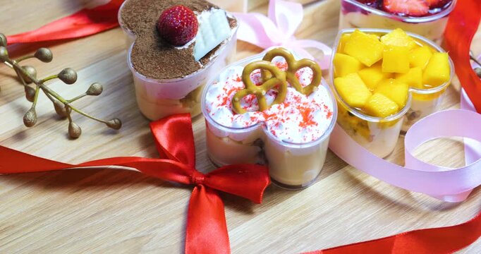Delicious heart shaped desserts are topped with fresh fruit, whipped cream, and chocolate, creating a sweet treat perfect for valentine's day celebrations