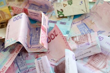 Big amount of different Ukrainian hryvnia money bills. Pile of crumpled ukrainian banknotes