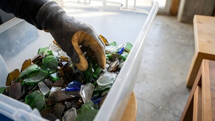 Person Sorting Recyclable Waste in a Bin.