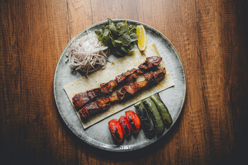 grilled lamb liver on a skewer served on plate © Sam