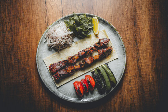 grilled lamb liver on a skewer served on plate