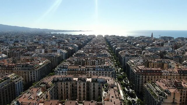 Stunning aerial perspective of a dense European city with a unique grid layout leading to the sea on a sunny day