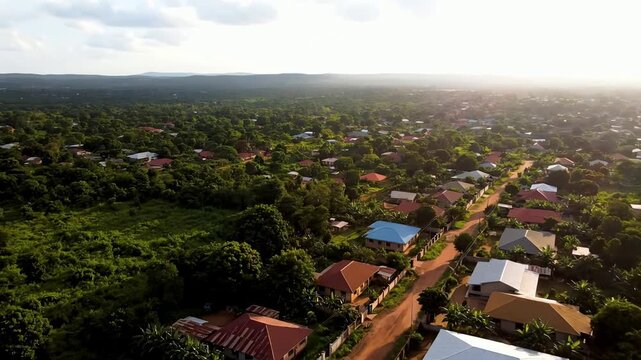 Scenic aerial drone flight over a peaceful village with colorful houses nestled in a lush green forest
