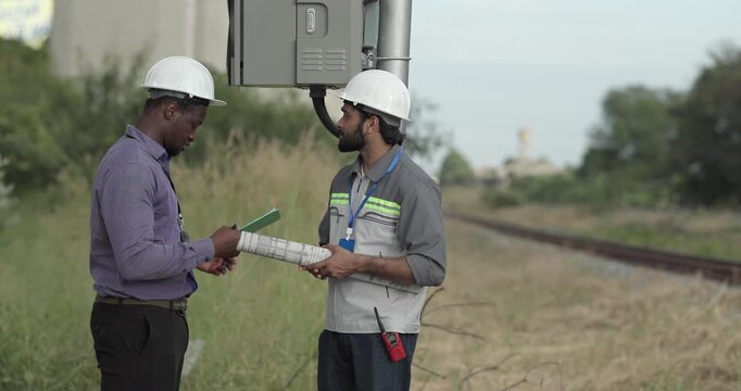 Engineer presents railway development proposal to investor during site visit, discussing green initiatives, future expansion, regional growth, Professional collaboration, stakeholder engagement 
