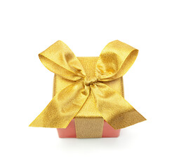 Golden ribbons  and Red color Christmas Gift Box white and golden lighting blur background