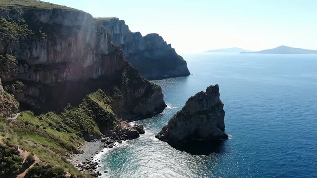 Breathtaking aerial footage of a rocky island coastline and a sea stack