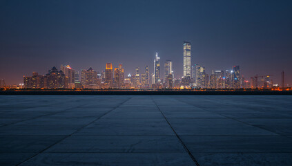 Beautiful cityscape view featuring illuminated skyscrapers and a tranquil plaza in the foreground