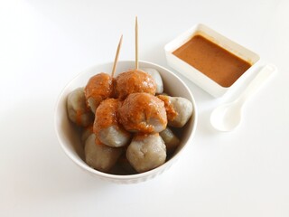 Cilok is a traditional food from Bandung, West Java, Indonesia. This food made from tapioca flour and serve with spicy peanut sauce