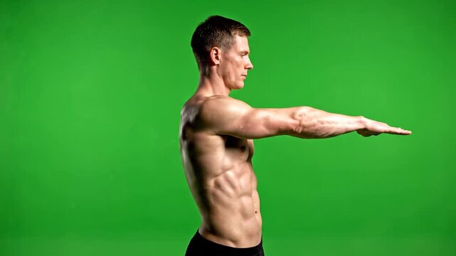 Shirtless Muscular Man Warming Up on Green Screen Background with arms outstretched at shoulder level Demonstrating Exercise Techniques Isolated
