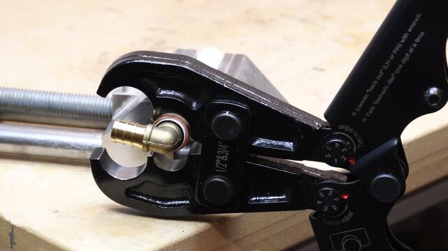 PEX crimping tool. Plastic tubing and elbow with dual size crimping tool.