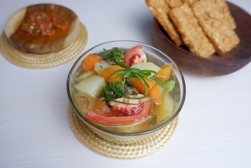 chicken soup with vegetables. Consommé soup with vegetables and Vienna sausage