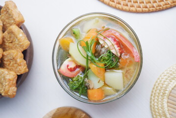 Chicken soup with vegetables in bowl. white background.  Top view.