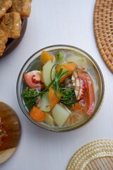 chicken soup with vegetables. Consommé soup with vegetables and Vienna sausage