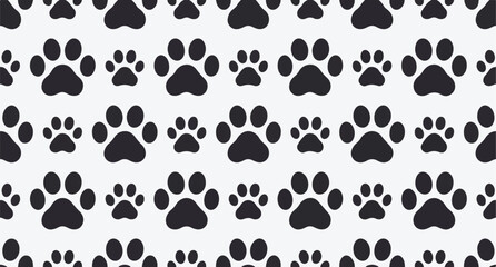 Seamless pattern of black paw prints of various sizes on a light gray background