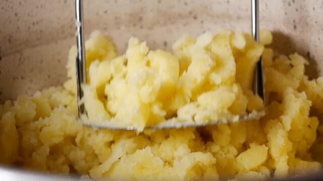 Making mashed potatoes in a kitchen mixer with butter