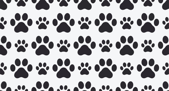 Seamless pattern of black paw prints of various sizes on a light gray background