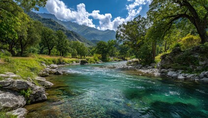 Azure river flows through lush green valley, mountains in background, under a blue sky