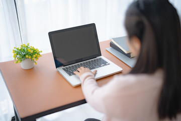 Pregnant asian woman using laptop at home pregnant businesswoman typing on laptop working on remote project in home office pregnancy