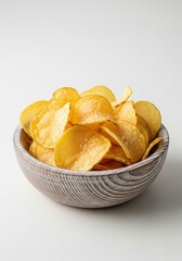 Potato Chips in Wooden Bowl on White Background for snack concepts, junk food themes, packaging, or advertising visuals.