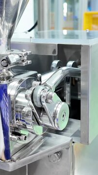 Video showing the operation of a piston-type lever arm in a skin cream filling machine.
