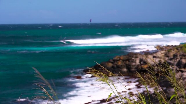 Windsurfers riding waves at Hookipa beach in Maui Hawaii