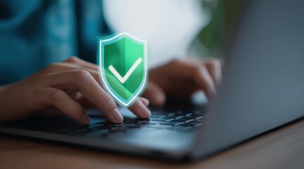 Hands typing on laptop keyboard with green security shield checkmark overlay for cybersecurity and data protection in online transactions and banking