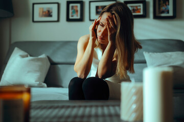 Woman Suffering a Severe Migraine at Home Feeling Sick. Unhappy depressed lady being in pain from a...