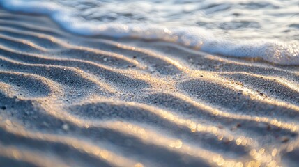 Sand waves on a beach at sunset.