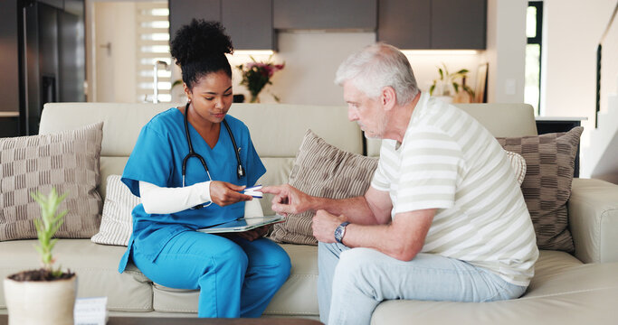 Lancet, checkup and nurse with senior man on sofa in home for blood sugar test for diabetes. Consultation, discussion and medical caregiver with elderly male patient for glucose kit in living room. - Powered by Adobe