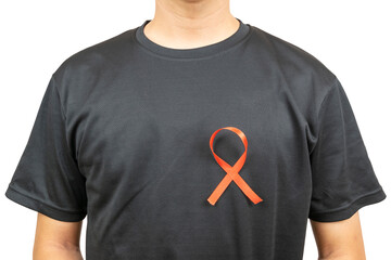 A close-up of a person wearing a black T-shirt with a red ribbon pinned on the chest, symbolizing HIV/AIDS awareness and support.
