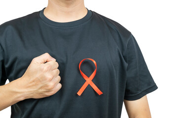 A close-up of a person wearing a black T-shirt with a red ribbon pinned on the chest, symbolizing HIV/AIDS awareness and support.