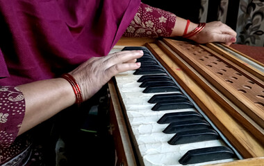 Woman Hand Playing Harmonium Keyboard. Traditional Indian Musical Instrument