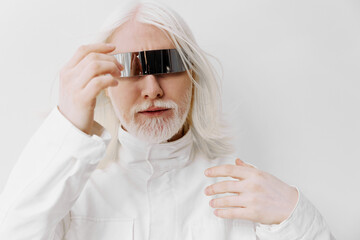 Futuristic man with silver hair wearing reflective glasses, set against a bright white background, showcasing a modern and avant garde aesthetic