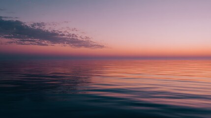 Fototapeta premium Serene Ocean Horizon at Sunset with Soft Clouds and Reflective Water.
