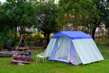 Summer camping in the forest with a green tent offers a perfect outdoor tourism adventure in nature