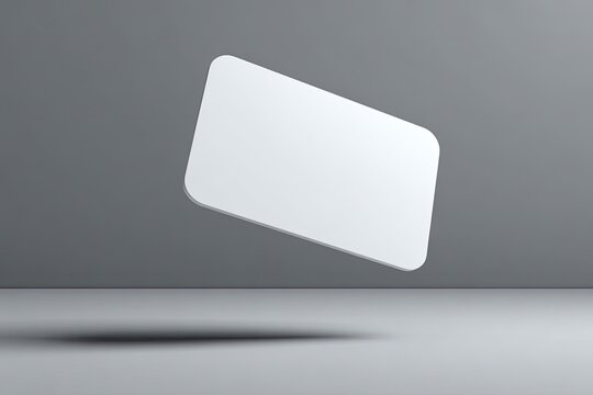 A blank, hovering, rectangular object with rounded corners, against a simple grey backdrop