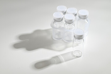 Close up of Empty Glass Vials with One Filled with Lyophilized Substance 