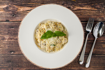 Creamy mushroom pasta topped with grated Parmesan and fresh basil