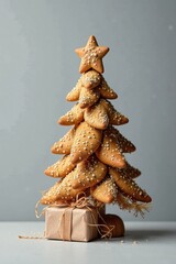 A Festive Delicacy Sweet Treats Shaped into a Charming Christmas Tree with a Small Gift Below
