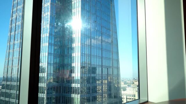 Office conference room with city building view, bright sunlight, business meeting concept, cityscape.