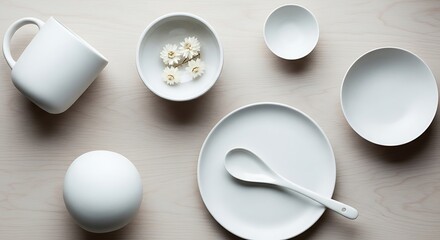 Minimalist Overhead Display of White Dishes and Delicate Floral Arrangement
