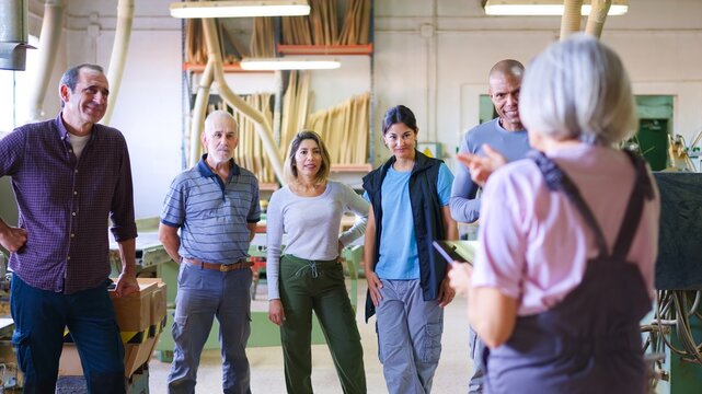 Workers team having a meeting in a woodworking shop
