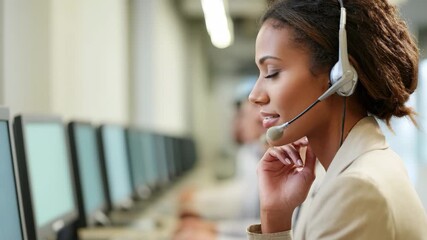 Young woman with headset working in a busy call center with colleagues in background customer service - Powered by Adobe
