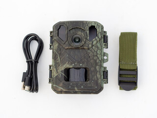 Wildlife camera kit with accessories. Mini hunting photo trap with 4k video. Outdoor mini hunting camera on white background